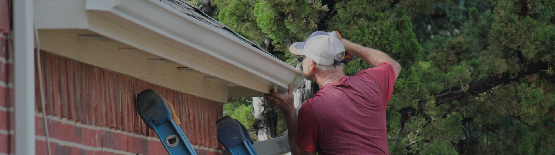 man repairing gutter